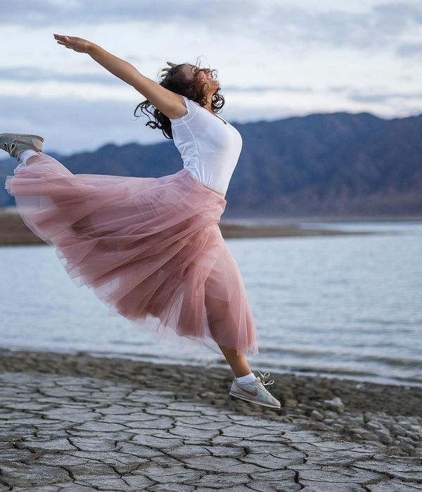 Woman feeling energetic and happy outdoors in nature.